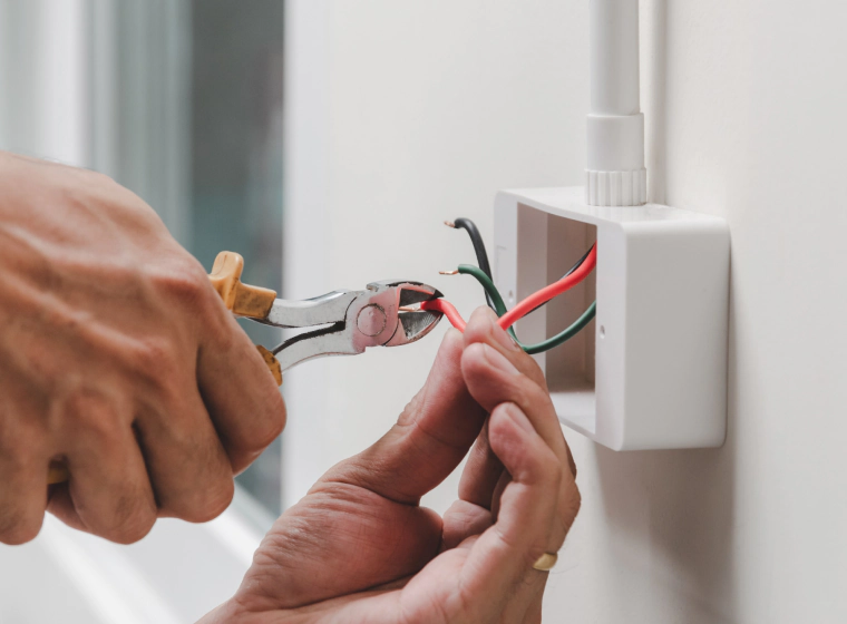 worker installing some outlets on a new house